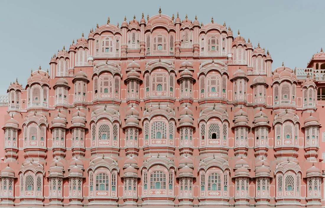 The pink sandstone architecture of Hawa Mahal in Jaipur, illustrating House of Raj’s journeys to India.